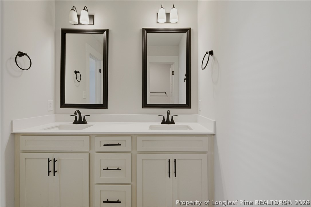 3931 Hamilton Street Hope Mills, NC 28348 - Photo 34 of 50 a bathroom with double sink a two mirror and a