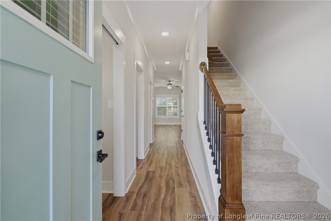 3931 Hamilton Street Hope Mills, NC 28348 - Photo 6 of 50 a view of a hallway with wooden floor and staircase