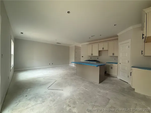 a kitchen with kitchen island a sink appliances and a window