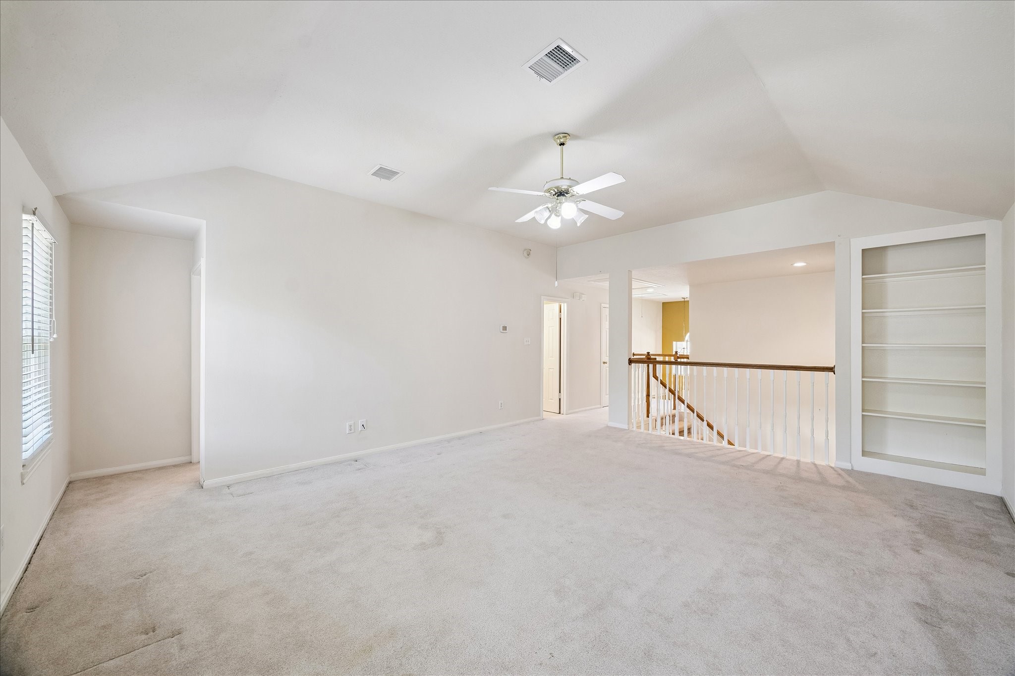 3007 Sycamore Tree Court Houston, TX 77345 - Photo 19 of 24 an empty room with chandelier fan and windows