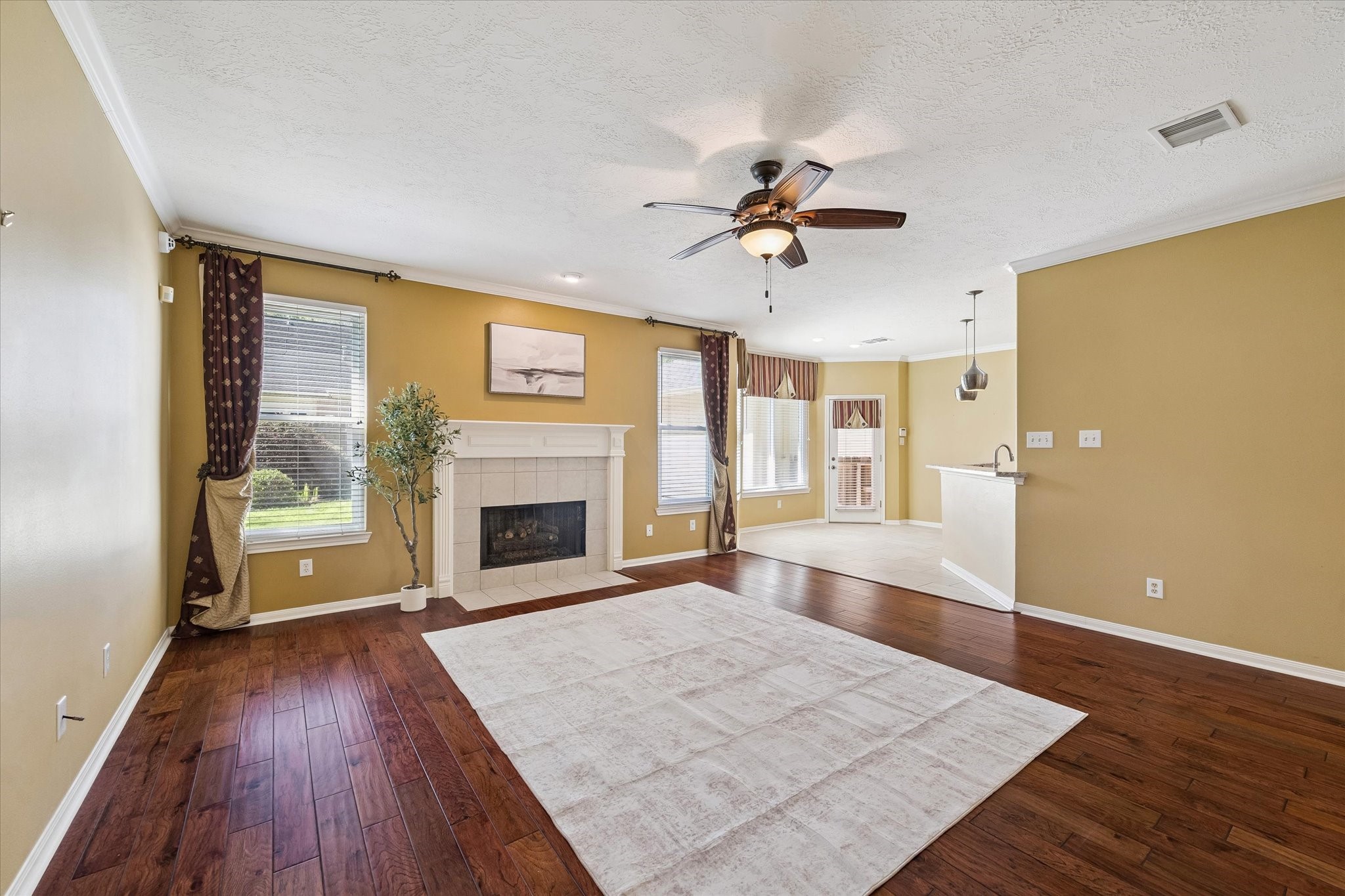 3007 Sycamore Tree Court Houston, TX 77345 - Photo 8 of 24 a view of a living room with a fireplace and wooden floor