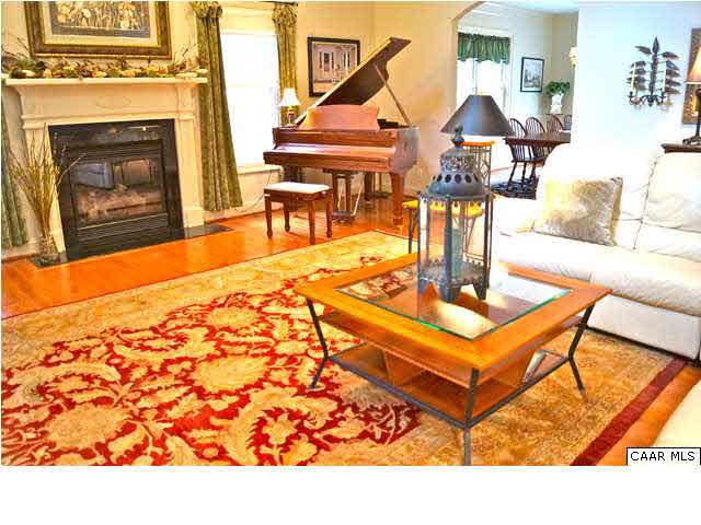 a living room with furniture a rug and a fireplace
