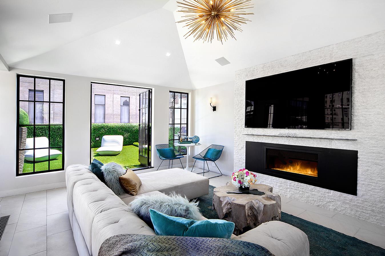 a living room with furniture a flat screen tv and a fireplace