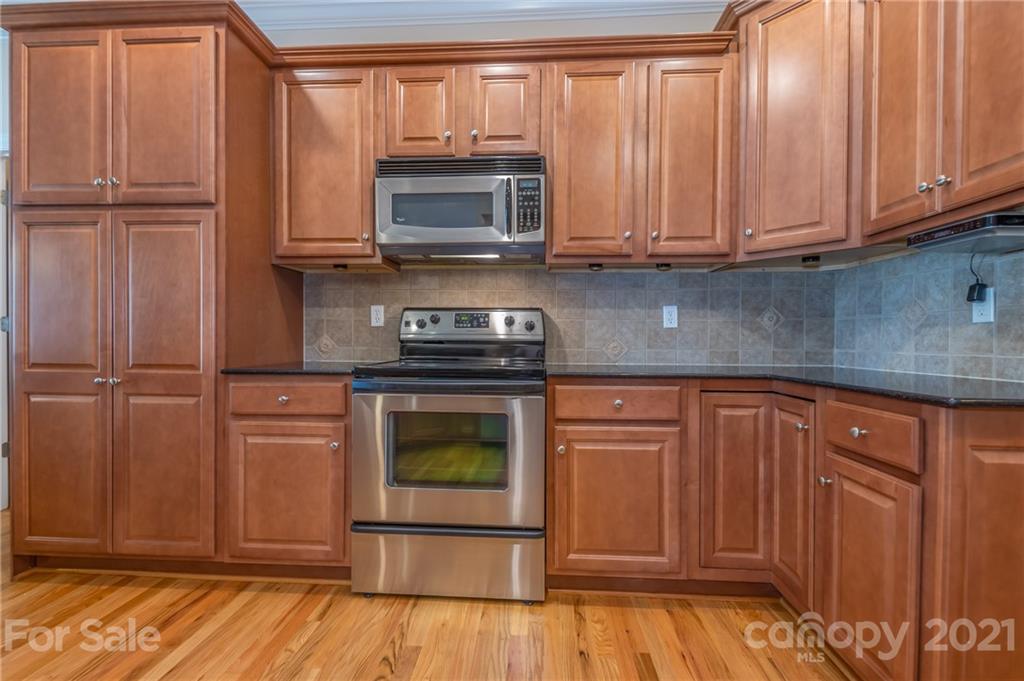 456 Cobblestone Drive Inman, SC 29349 - Photo 13 of 36 a kitchen with wooden cabinets and a stove top oven