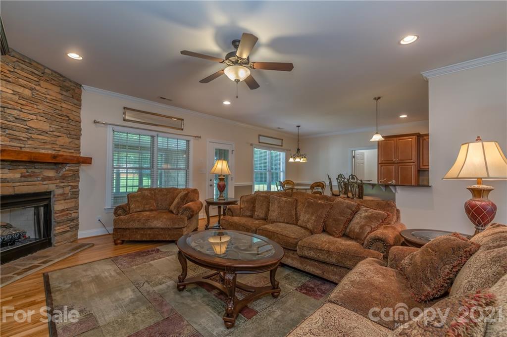 456 Cobblestone Drive Inman, SC 29349 - Photo 20 of 36 a living room with furniture a fireplace and a flat screen tv