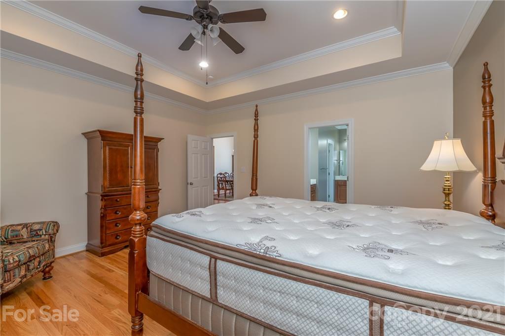 456 Cobblestone Drive Inman, SC 29349 - Photo 22 of 36 a bedroom with a bed and a chandelier