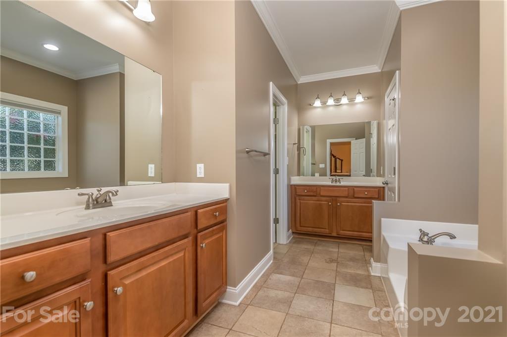 456 Cobblestone Drive Inman, SC 29349 - Photo 23 of 36 a bathroom with a granite countertop sink mirror and bathtub
