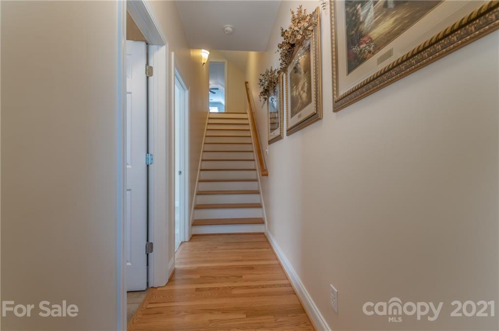 456 Cobblestone Drive Inman, SC 29349 - Photo 29 of 36 a view of a hallway with wooden floor and staircase