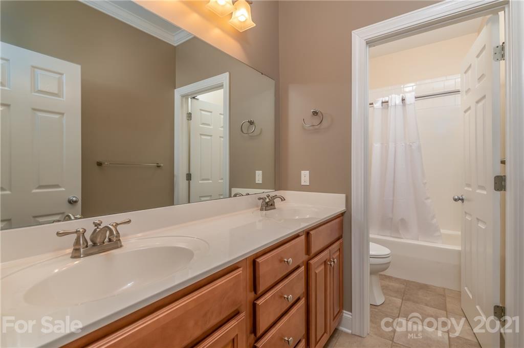 456 Cobblestone Drive Inman, SC 29349 - Photo 30 of 36 a bathroom with a granite countertop sink and a mirror