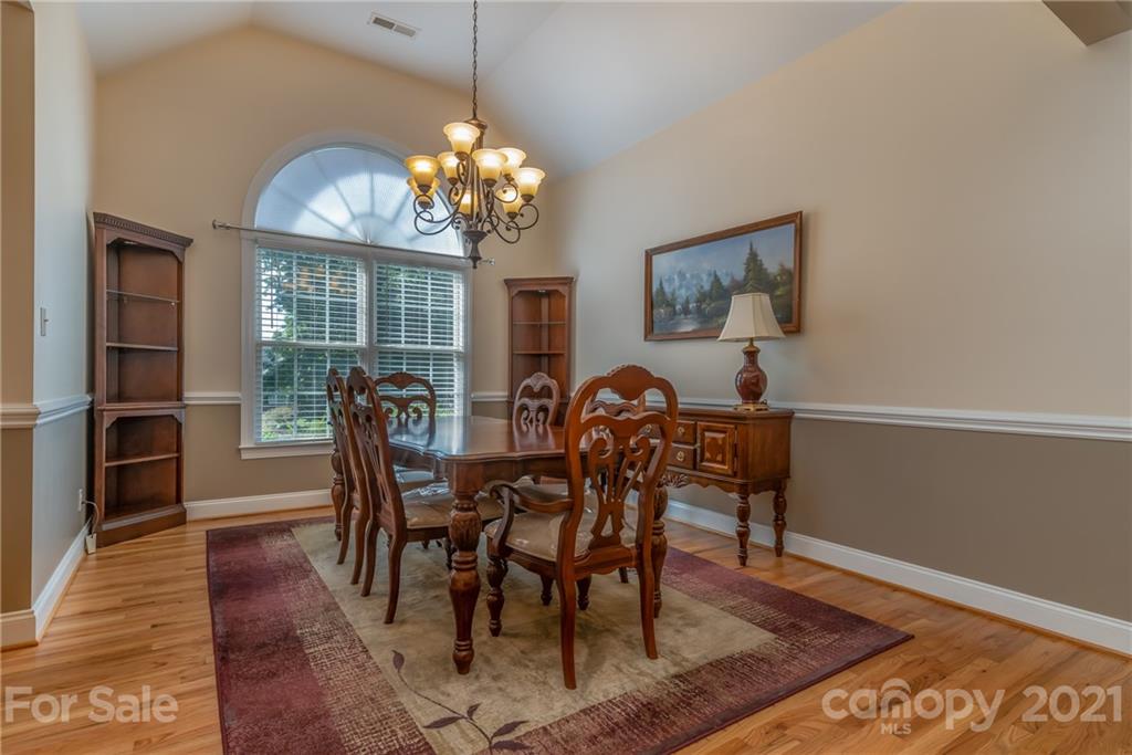 456 Cobblestone Drive Inman, SC 29349 - Photo 7 of 36 a view of a dining room with furniture a chandelier and wooden floor