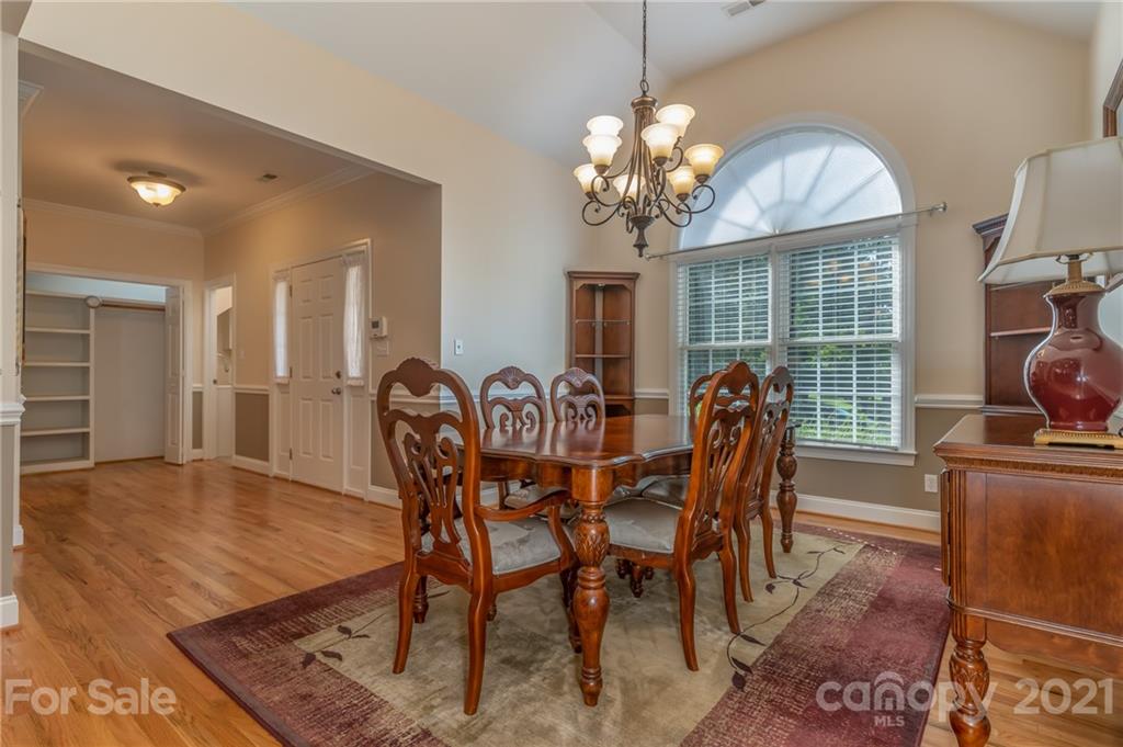 456 Cobblestone Drive Inman, SC 29349 - Photo 8 of 36 a view of a dining room with furniture a chandelier and wooden floor