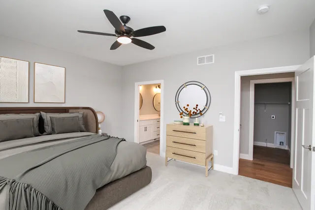 a bedroom with furniture and a mirror