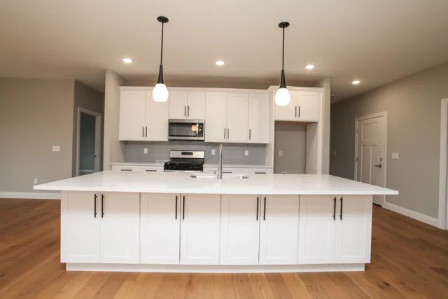 a large kitchen with stainless steel appliances kitchen island a large island in the center