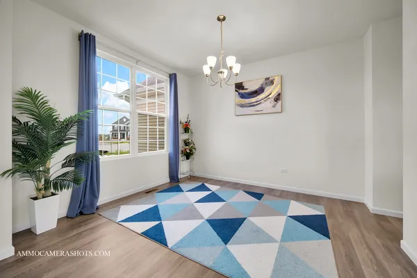 a view of a room with wooden floor and windows