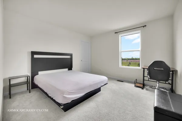 a bedroom with a bed and window