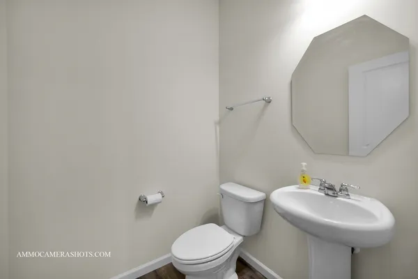a bathroom with a sink a mirror and a toilet