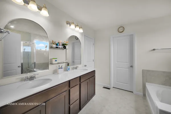 a bathroom with a double vanity sink and a mirror