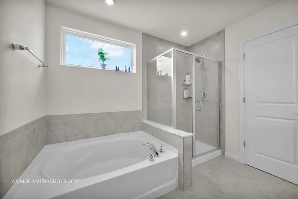 a spacious bathroom with a bathtub and shower