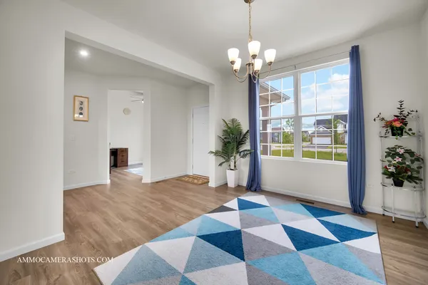 a very nice looking room with a window and a chandelier