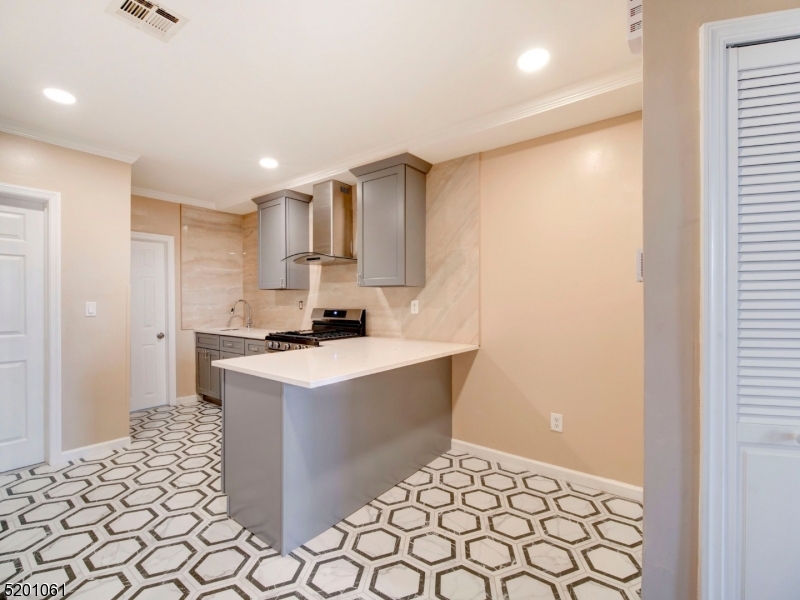 310 Broadway Newark, NJ 07104 - Photo 4 of 11 a kitchen with a sink cabinets and a refrigerator