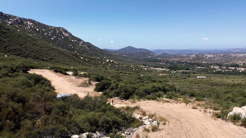 2413-2425 Oak Valley Trail Jamul, CA 91935 - Photo 17 of 40 a view of a lake with mountains in the background