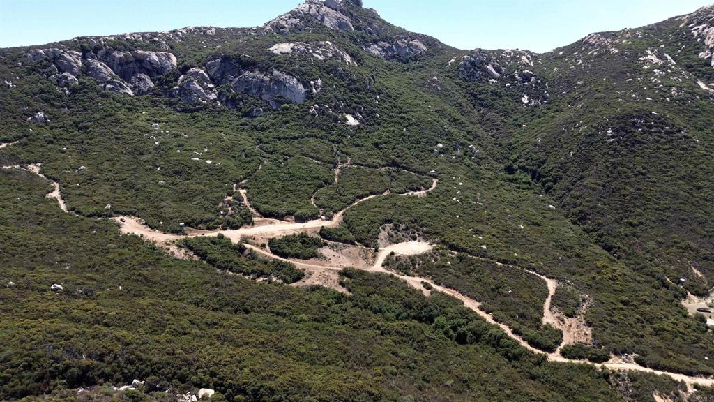 2413-2425 Oak Valley Trail Jamul, CA 91935 - Photo 20 of 40 a view of a house with a yard