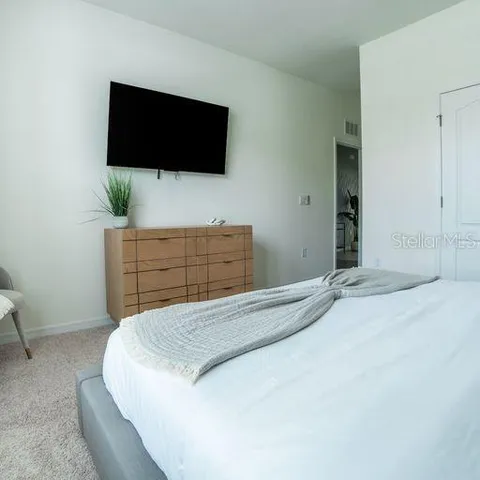 a bedroom with a bed and a mirror