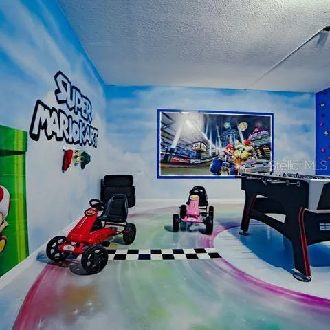 a living room with furniture a rug and a wall painting