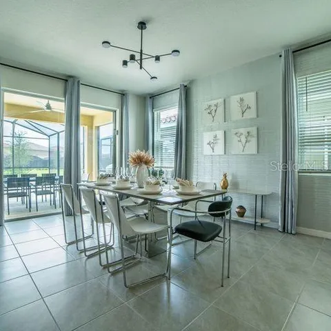 a living room with furniture a rug and white walls