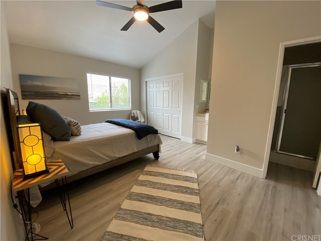 9960 Owensmouth Avenue, Unit 25 Chatsworth, CA 91311 - Photo 15 of 17 a bedroom with a bed and wooden floor