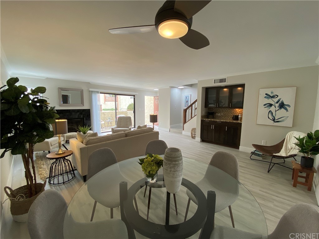 9960 Owensmouth Avenue, Unit 25 Chatsworth, CA 91311 - Photo 2 of 17 a living room with furniture kitchen view and a fireplace