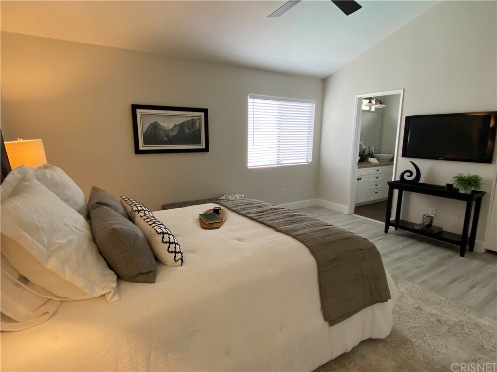 9960 Owensmouth Avenue, Unit 25 Chatsworth, CA 91311 - Photo 10 of 17 a bedroom with a bed and a flat screen tv