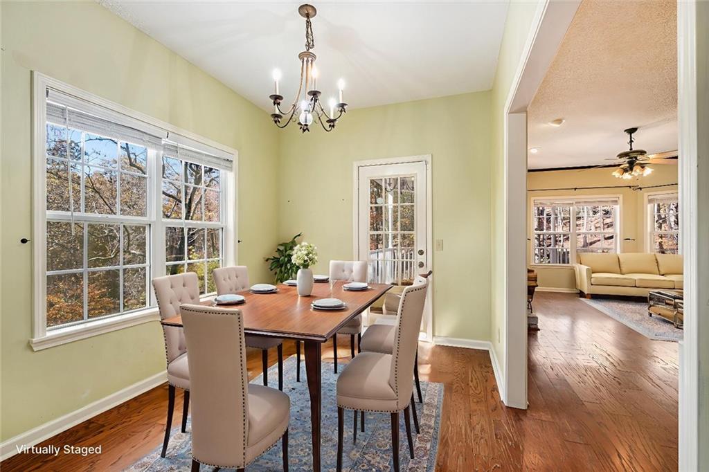 7929 Pea Ridge Road Lula, GA 30554 - Photo 11 of 35 a view of a dining room with furniture window and wooden floor