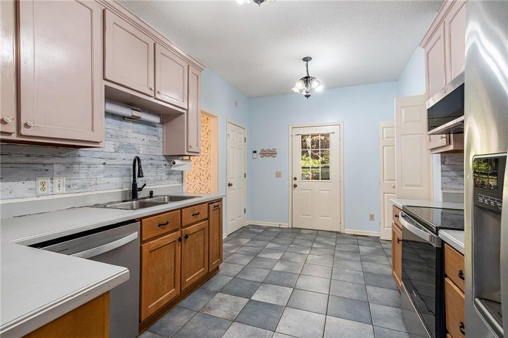 7929 Pea Ridge Road Lula, GA 30554 - Photo 13 of 35 a kitchen with stainless steel appliances a sink stove and cabinets