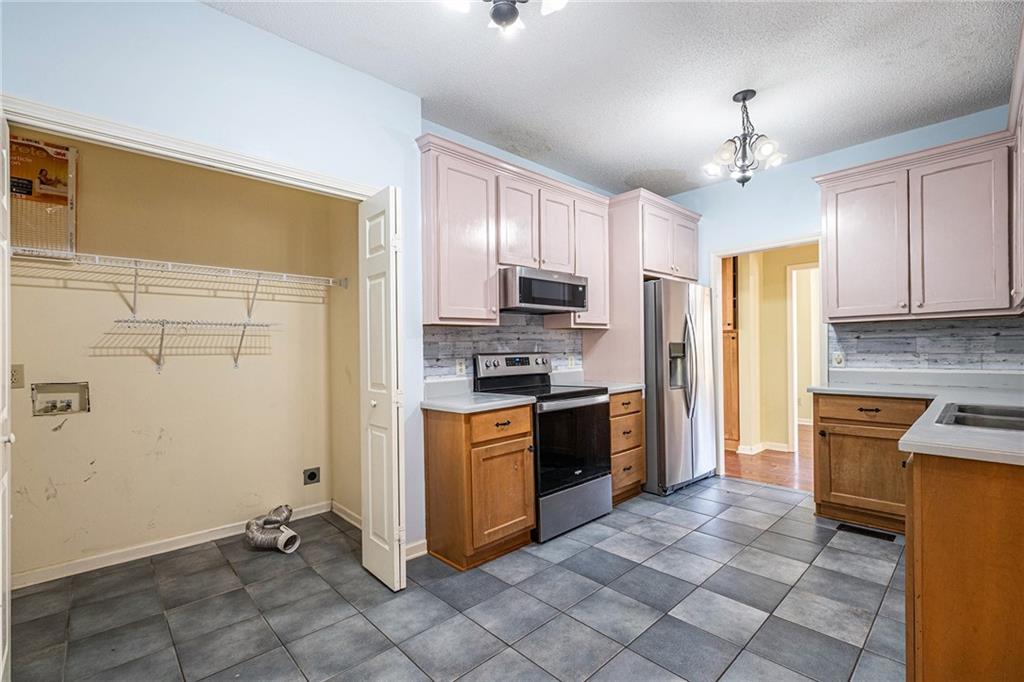 7929 Pea Ridge Road Lula, GA 30554 - Photo 14 of 35 a kitchen with granite countertop a refrigerator stove top oven and sink
