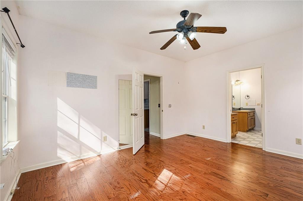 7929 Pea Ridge Road Lula, GA 30554 - Photo 19 of 35 a view of empty room with wooden floor and ceiling fan