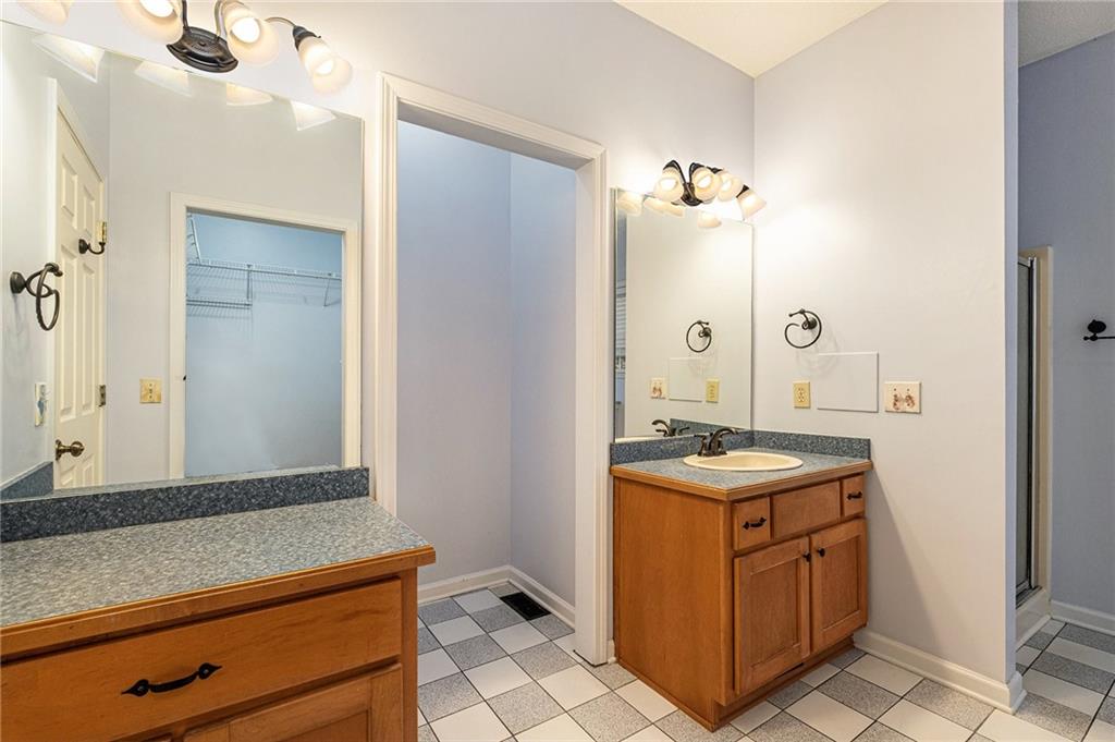 7929 Pea Ridge Road Lula, GA 30554 - Photo 20 of 35 a bathroom with a granite countertop sink a mirror and a