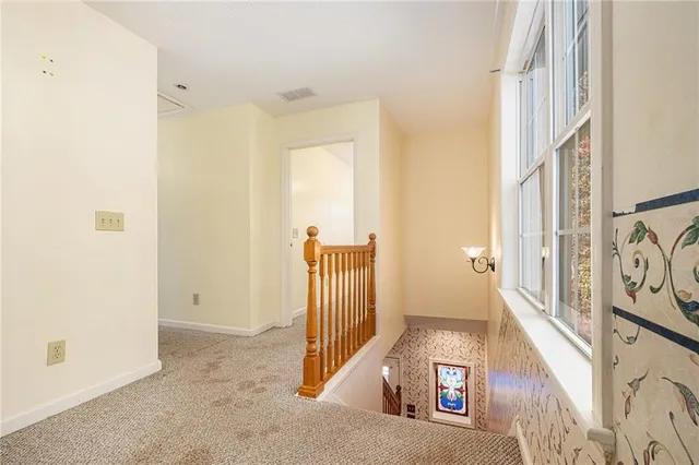 a view of a hallway with entryway wooden floor and front door