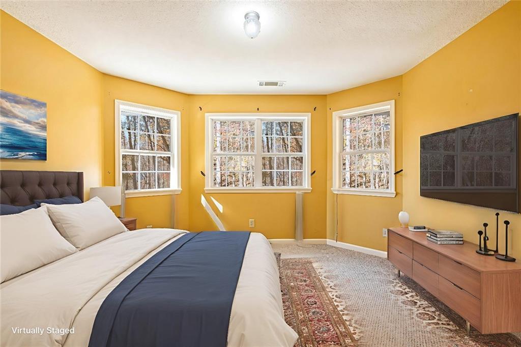 7929 Pea Ridge Road Lula, GA 30554 - Photo 25 of 35 a bedroom with a bed and a dresser next to a window