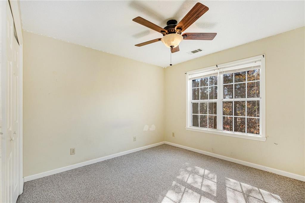 7929 Pea Ridge Road Lula, GA 30554 - Photo 28 of 35 an empty room with window and ceiling fan