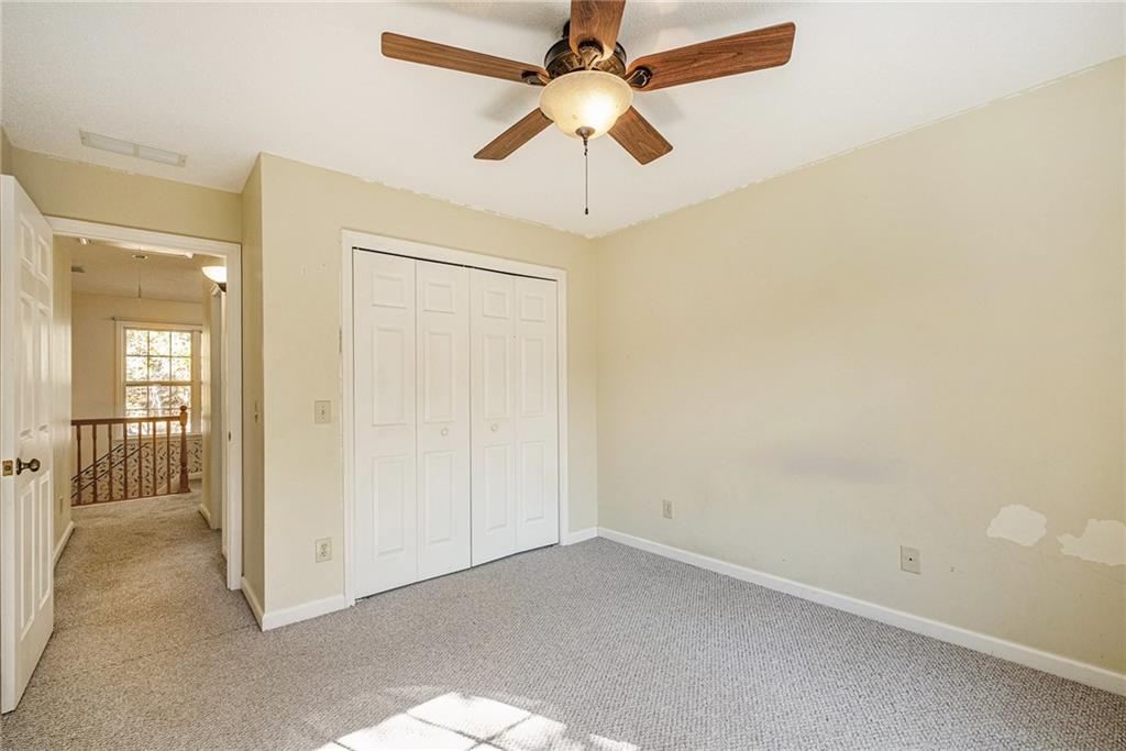 7929 Pea Ridge Road Lula, GA 30554 - Photo 29 of 35 an empty room with a ceiling fan and a window
