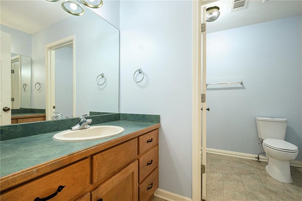 7929 Pea Ridge Road Lula, GA 30554 - Photo 30 of 35 a bathroom with a granite countertop sink toilet and shower