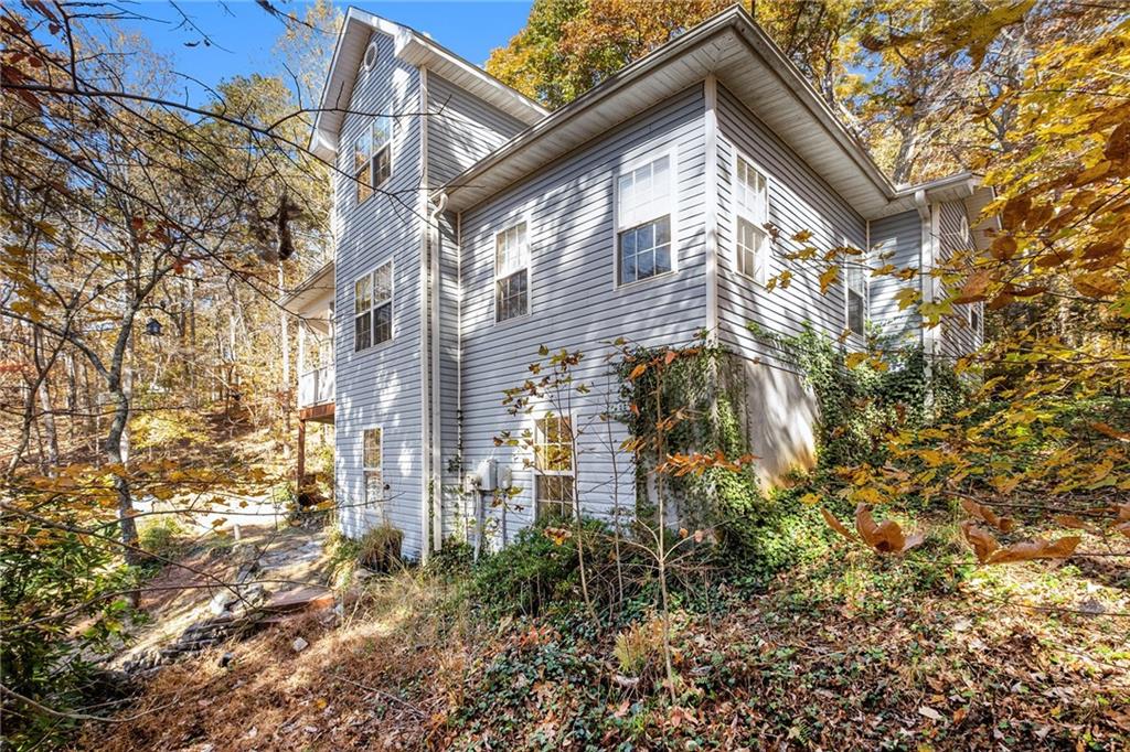 7929 Pea Ridge Road Lula, GA 30554 - Photo 34 of 35 a view of a brick house with a yard and large trees