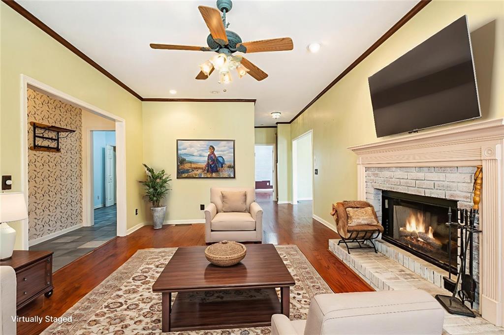 7929 Pea Ridge Road Lula, GA 30554 - Photo 9 of 35 a living room with furniture a flat screen tv and a fireplace