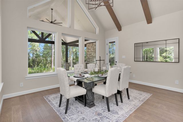 a view of a dining room with furniture a chandelier and wooden floor