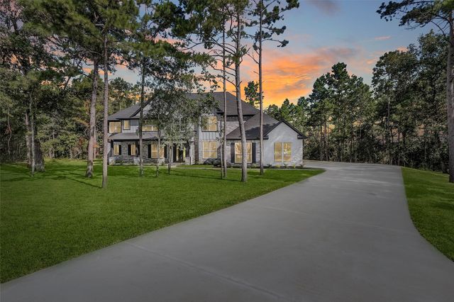a view of house with a big yard next to a yard