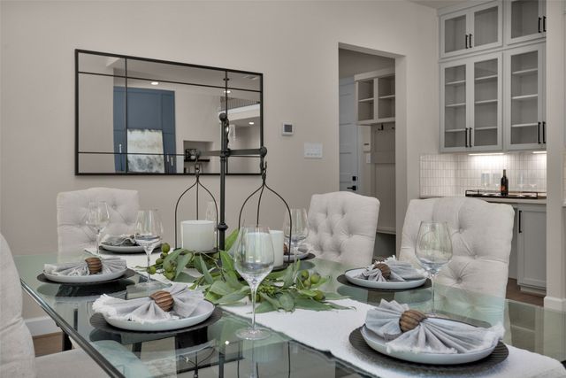 a dining room with furniture and wooden floor