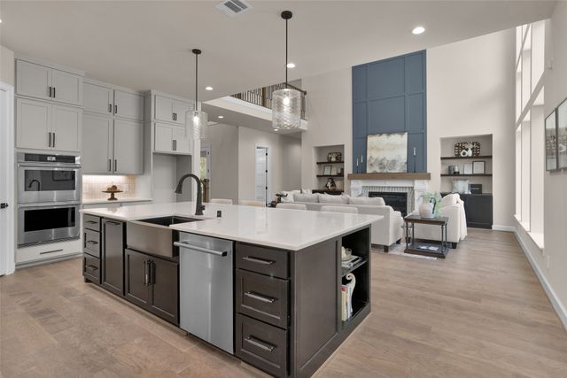 a kitchen with kitchen island granite countertop a sink counter top space stainless steel appliances and cabinets