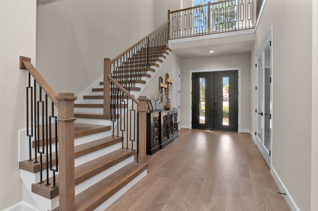 a view of a hallway with wooden floor and entryway