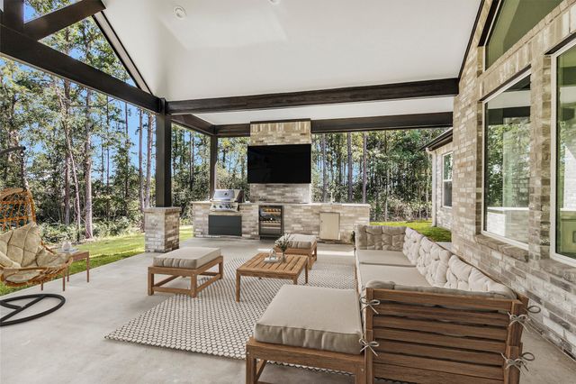 a living room with patio furniture and a flat screen tv